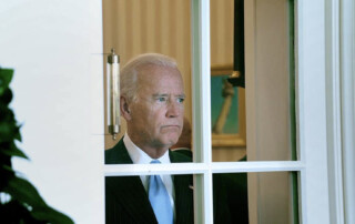 Joe Biden staring blindly out of oval office