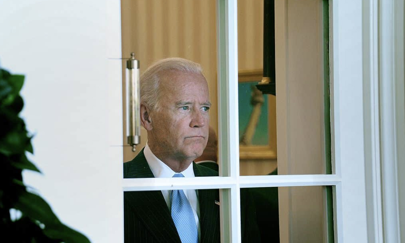 Joe Biden staring blindly out of oval office