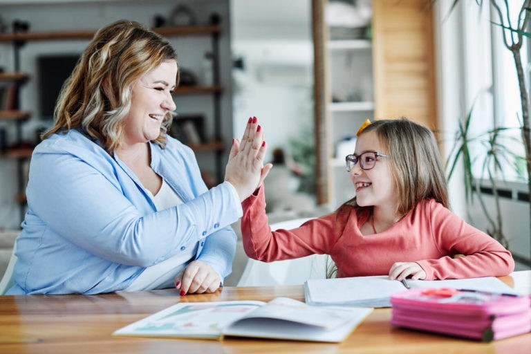 Mother helping child with homework